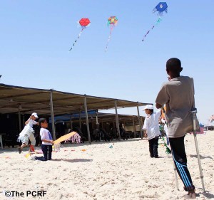In a picture taken by one of the young Gazans, children play with kites on the beach (Photo: Ibtesam Abu Thaher/PCRF)