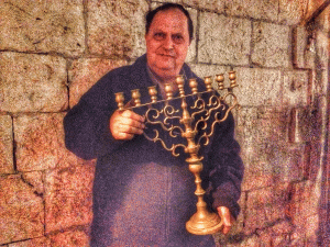 Yossef Shabtai holding the candelabrum he will light tonight