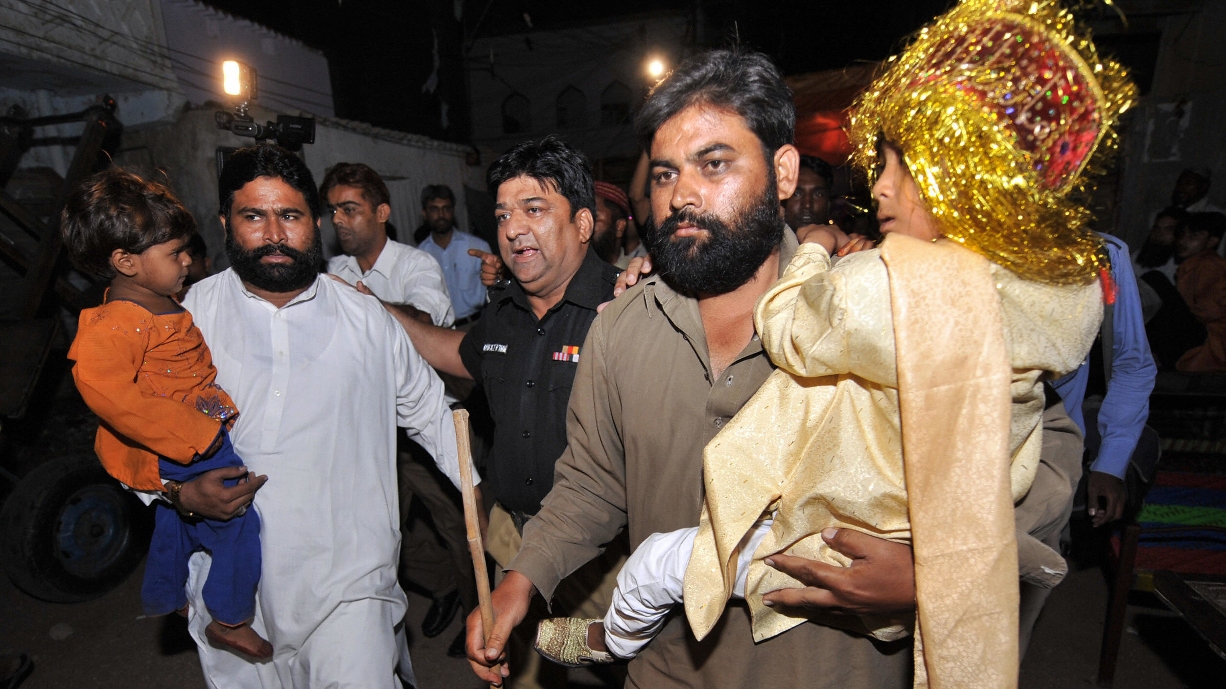 Pakistani National Ahmed Quddus Covers Himself With A Blanket As Police Escort Him