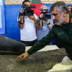 Gen. Amir Ali Hajizadeh, chief of the aerospace division of Iran’s Islamic Revolutionary Guard Corps, is shown in Tehran on June 21 displaying parts from a US drone the IRGC had downed the day before. (Meghdad Madadi/AFP via Getty Images)