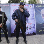 Palestinian Hamas policemen stand on guard next to the posters of Qasem Soleimani, the Iran's head of the Quds Force who was killed during the US airstrike in Gaza City, January 4. (Mahmoud Issa/SOPA Images/LightRocket via Getty Images)