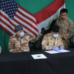 US Army Brig. Gen. Vincent Barker (R), Iraqi Army Staff Maj. Gen. Mohammad Fadhel Abbas (2nd R) and Iraqi Air Force Maj. Gen. Shehab Zahed Ali (2nd L) attend a pullout ceremony at Qayyarah air base, where US-led troops in 2017 helped Iraqis plan fight against ISIS in nearby Mosul, on March 26, 2020. (Ahmad al-Rubaye/AFP via Getty Images)