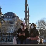 Women wear protective face masks sitting near the Sultanahmet Mosque, also known as the Blue Mosque, as the nation tries to contain the novel coronavirus in Istanbul, March 17, 2020. (Ozan Kose/AFP via Getty Images)